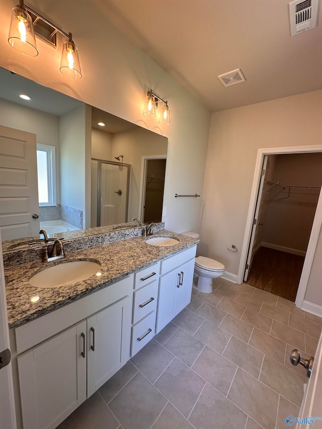 full bathroom with tile patterned flooring, vanity, separate shower and tub, and toilet