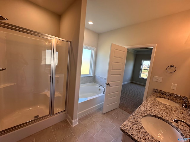 bathroom with tile patterned flooring, vanity, and shower with separate bathtub