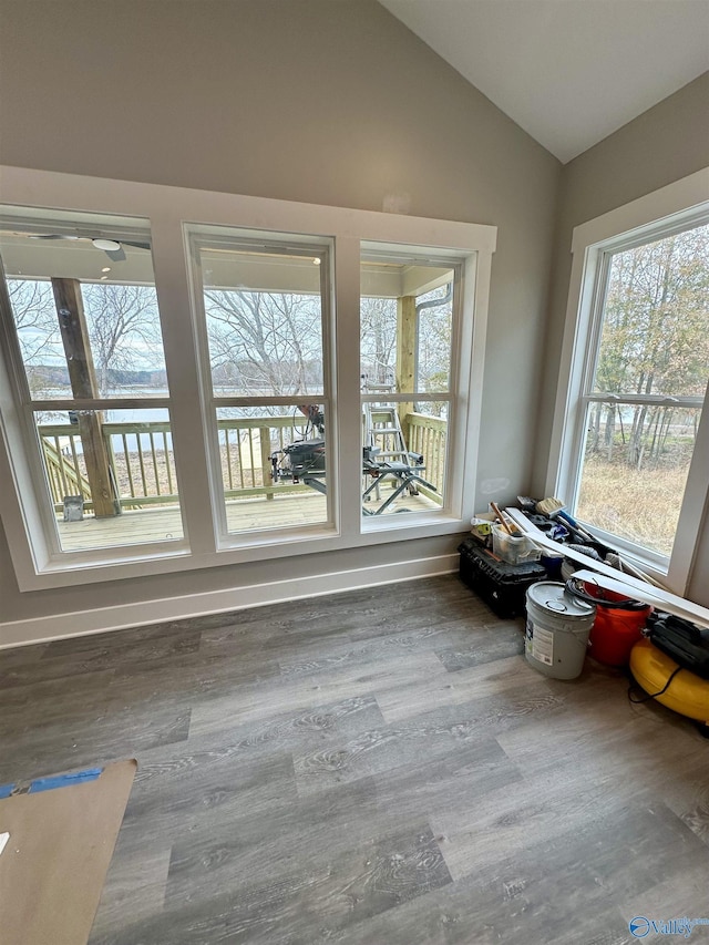 unfurnished sunroom with a healthy amount of sunlight and lofted ceiling