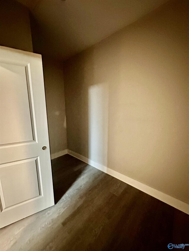 spare room with wood-type flooring