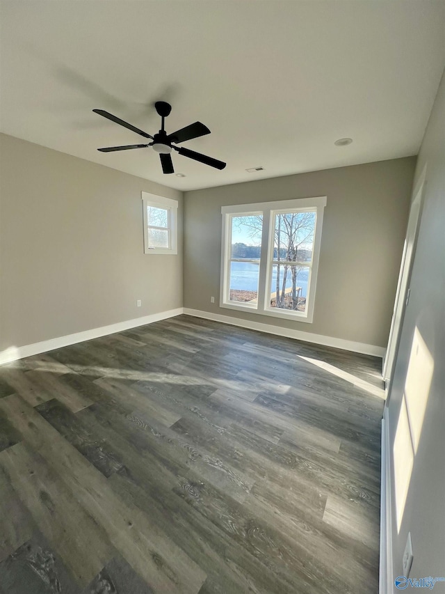 unfurnished room featuring dark hardwood / wood-style floors and ceiling fan