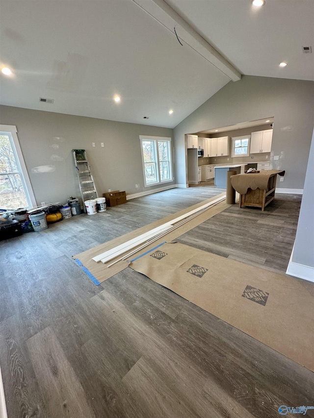 misc room with lofted ceiling with beams and hardwood / wood-style flooring