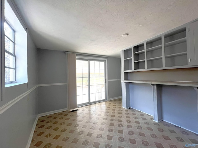 interior space with a textured ceiling