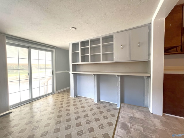 unfurnished office with a textured ceiling