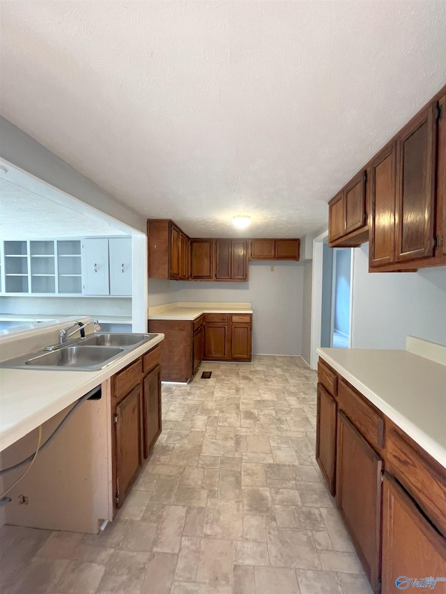 kitchen featuring a textured ceiling and sink