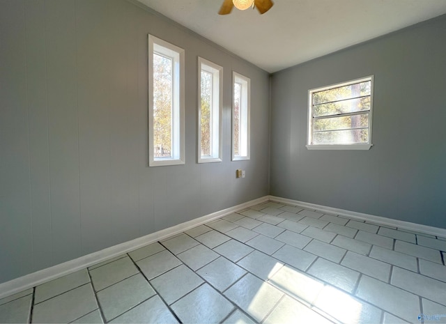 tiled spare room featuring ceiling fan