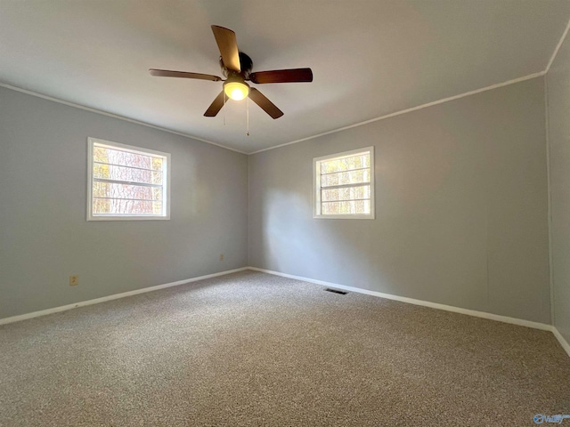 unfurnished room featuring carpet floors, a healthy amount of sunlight, and ceiling fan