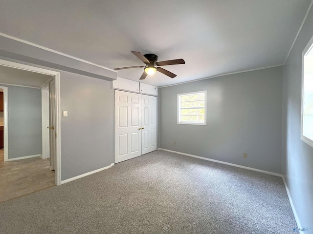 unfurnished bedroom featuring a closet, carpet flooring, and ceiling fan