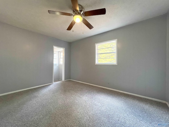 spare room with ceiling fan and a textured ceiling