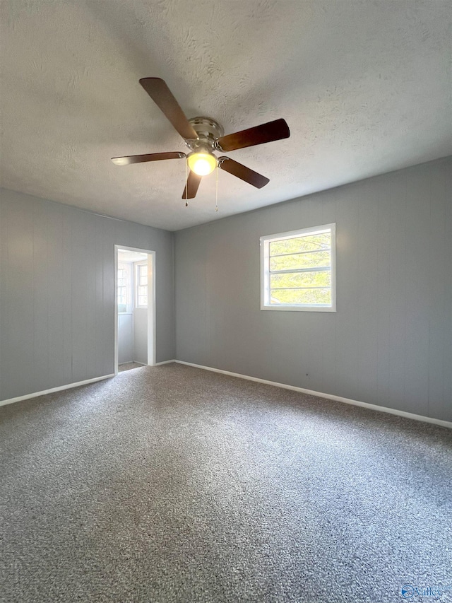 unfurnished room featuring a textured ceiling and ceiling fan