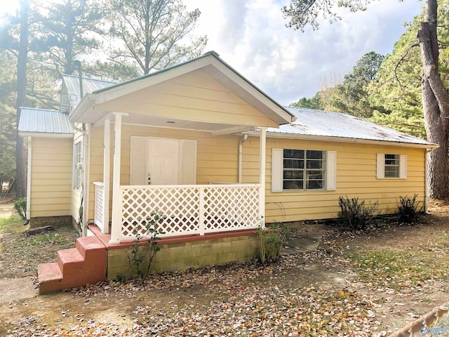 view of property exterior featuring covered porch