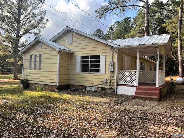 rear view of property with covered porch