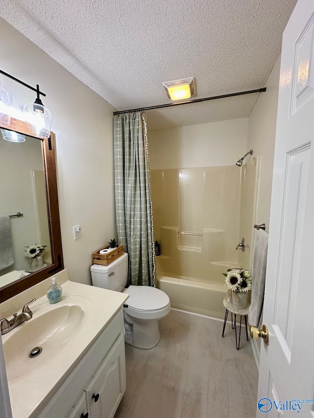 bathroom with toilet, shower / bathtub combination with curtain, a textured ceiling, and vanity