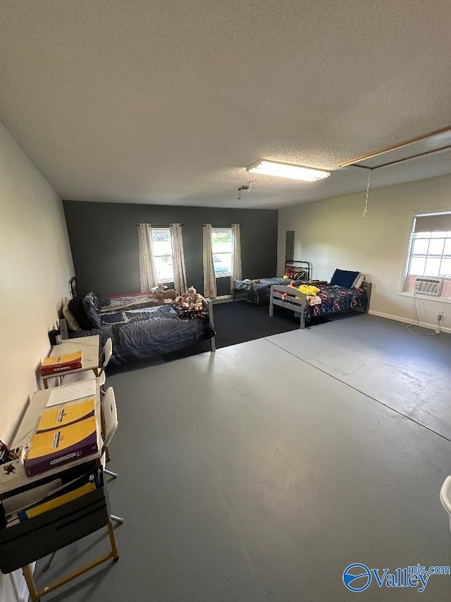 bedroom with a textured ceiling, concrete floors, and electric panel