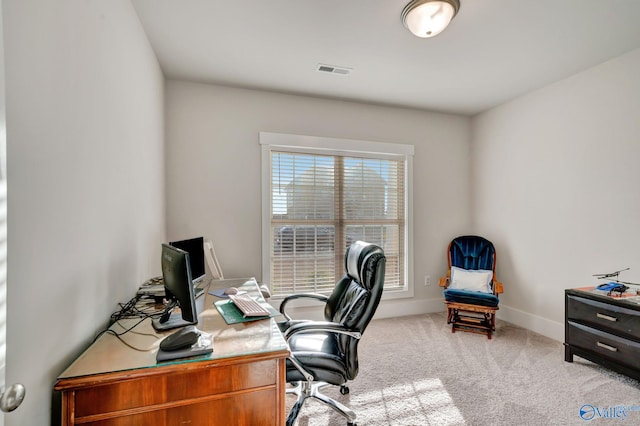 office space with light carpet, baseboards, and visible vents