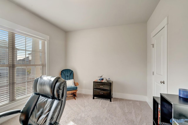 carpeted office space featuring baseboards