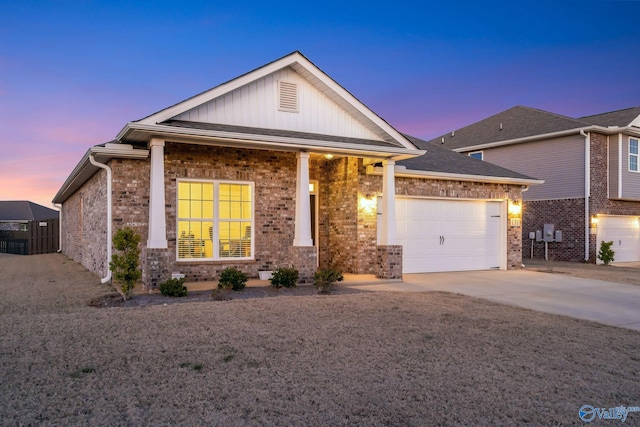 view of front facade featuring a garage, concrete driveway, and brick siding