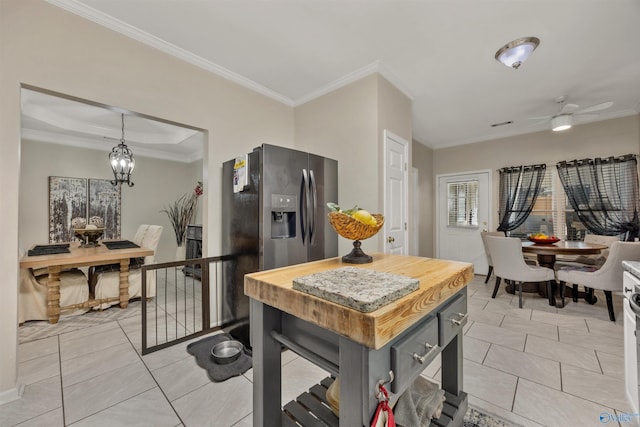 kitchen with ornamental molding and wooden counters