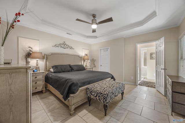bedroom with ornamental molding, light tile patterned floors, visible vents, and a tray ceiling