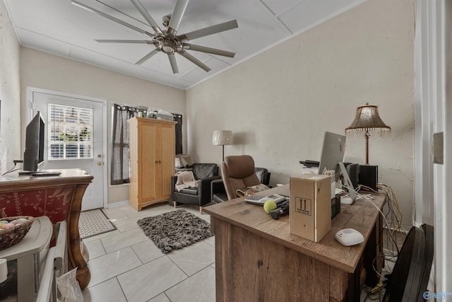 office featuring light tile patterned floors and ceiling fan