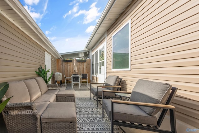 view of patio / terrace featuring outdoor lounge area and fence