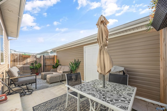view of patio featuring fence, central air condition unit, and an outdoor hangout area