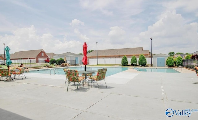 pool featuring a patio area and fence