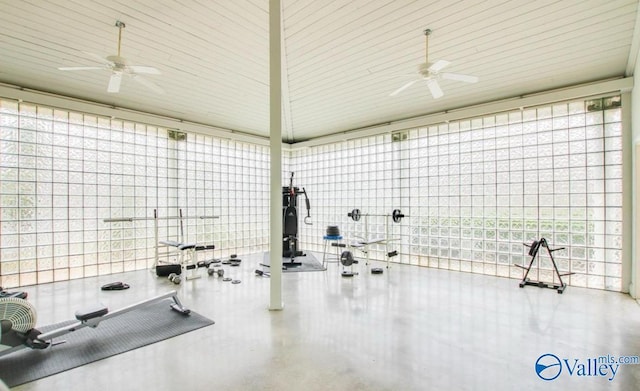 workout room with a towering ceiling and ceiling fan