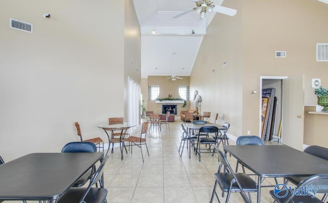 dining space featuring visible vents, high vaulted ceiling, and a ceiling fan