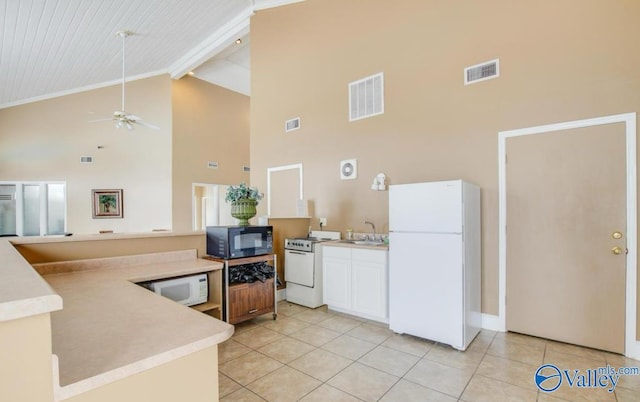 kitchen featuring visible vents, high vaulted ceiling, and white appliances