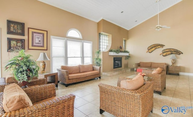 living area with high vaulted ceiling, light tile patterned floors, and crown molding
