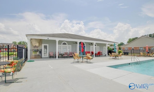 pool featuring fence, a ceiling fan, and a patio