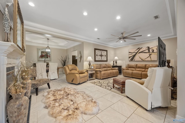 living area with recessed lighting, ceiling fan, a fireplace, visible vents, and a tray ceiling
