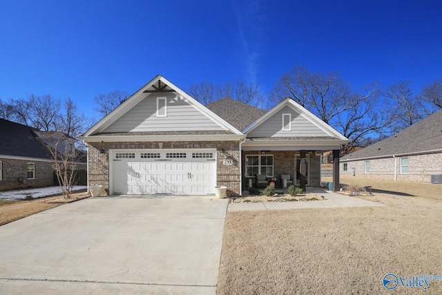 view of front of house with a garage, central AC unit, and a porch