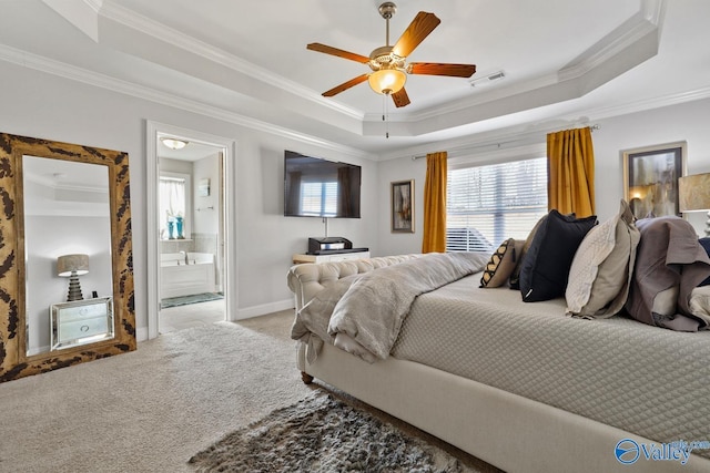 bedroom with ornamental molding, a raised ceiling, ceiling fan, light colored carpet, and ensuite bathroom