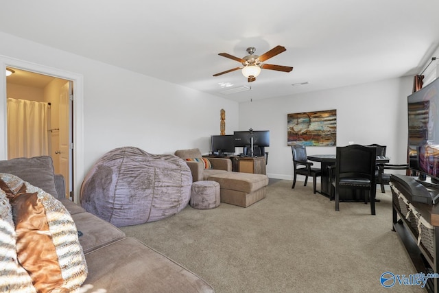 carpeted living room featuring ceiling fan