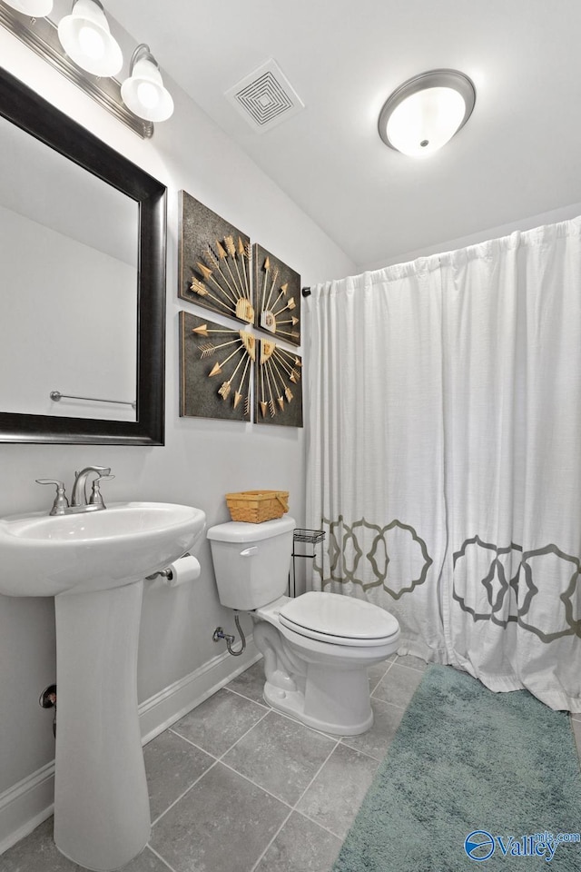 bathroom with sink, toilet, and tile patterned floors