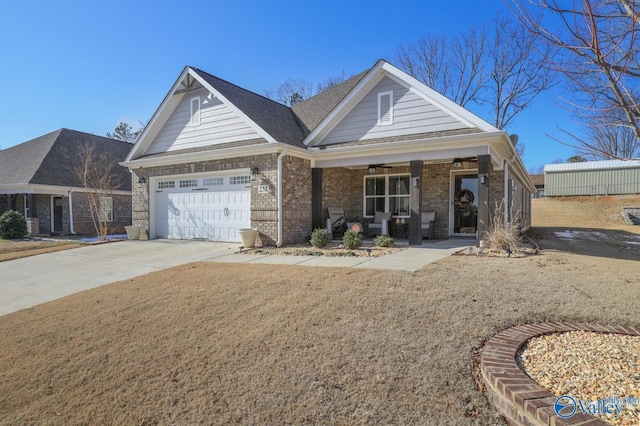 view of front of home featuring a garage, a front lawn, and a porch