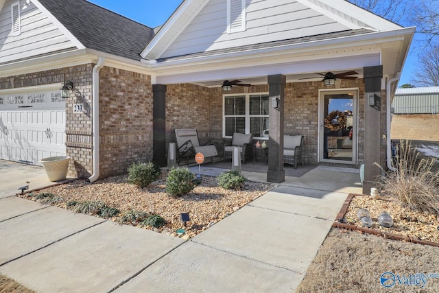 doorway to property with a porch, a garage, and ceiling fan