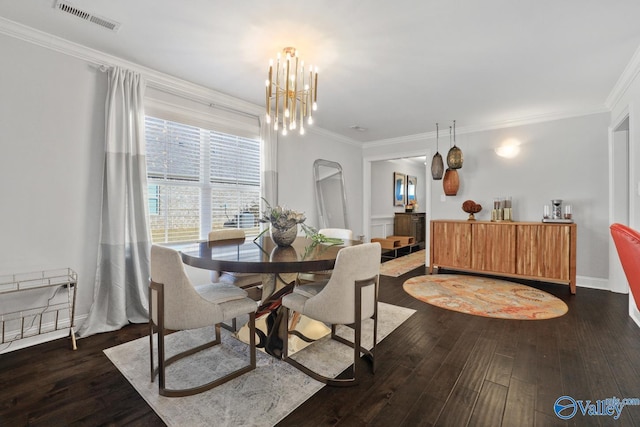 dining room featuring ornamental molding, dark hardwood / wood-style floors, and an inviting chandelier