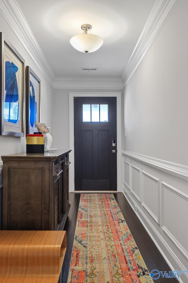 doorway featuring ornamental molding and dark wood-type flooring