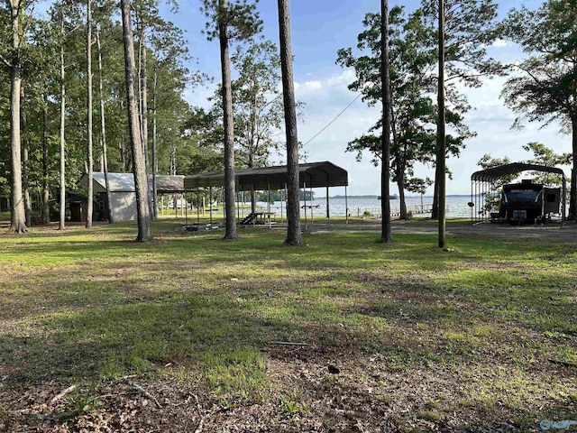 1165 Sunset Dr, Leesburg, AL 35983 - view of grassy yard with a detached carport and a water view