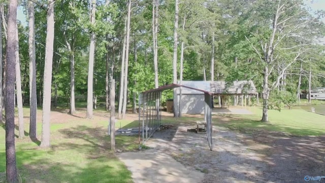 1165 Sunset Dr, Leesburg, AL 35983 - view of community featuring an outdoor structure, view of wooded area, and a lawn