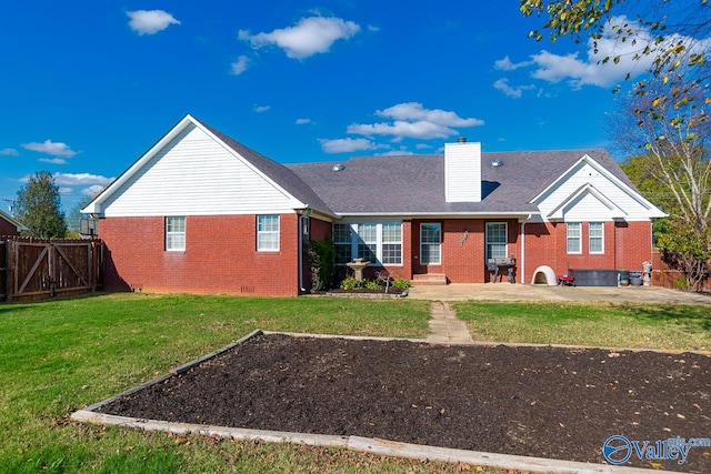 rear view of property featuring a lawn