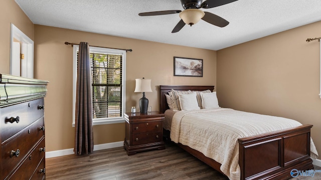 bedroom with baseboards, a ceiling fan, a textured ceiling, and dark wood-style floors