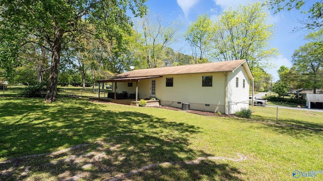 rear view of property featuring a lawn, crawl space, fence, and a patio
