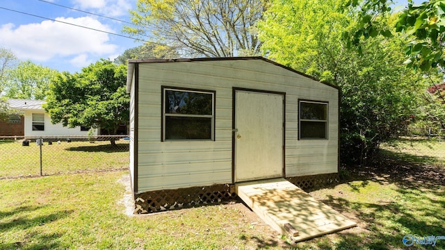 view of shed featuring fence