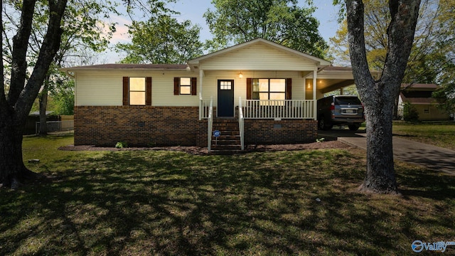 view of front of house featuring concrete driveway, a carport, a porch, and a front yard