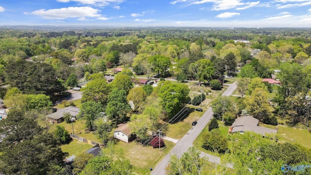birds eye view of property featuring a view of trees