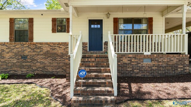 doorway to property with a porch